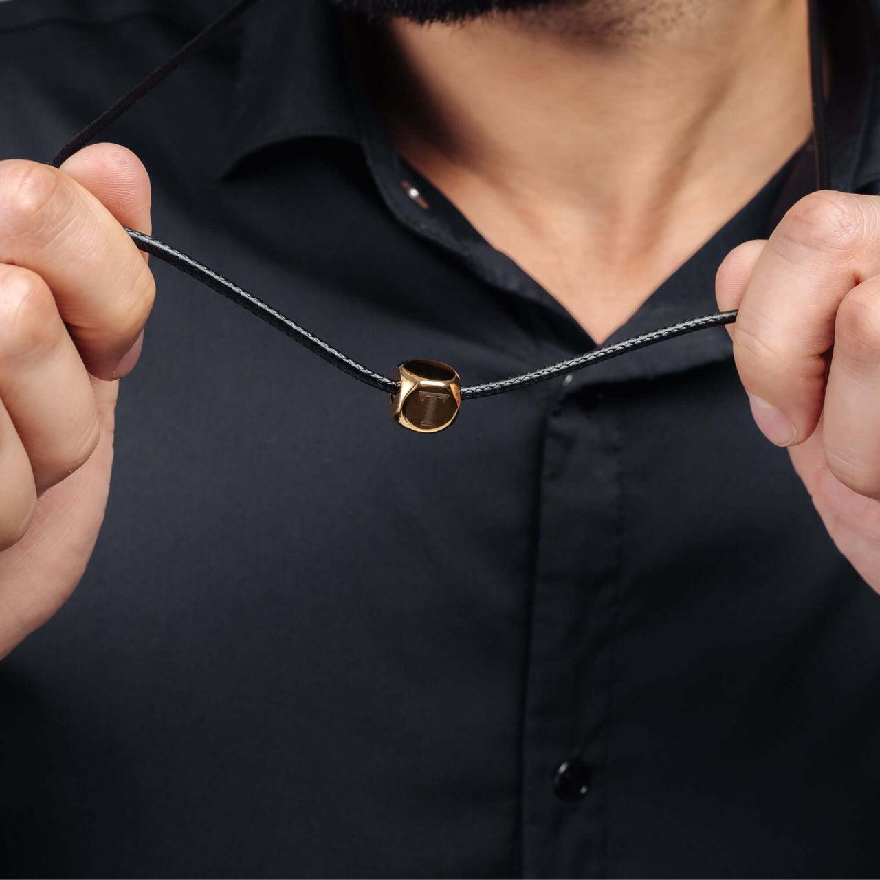 Gold Cube Initial Necklace worn by a man, showcasing the bold and minimalistic design from Brother & Sisters.