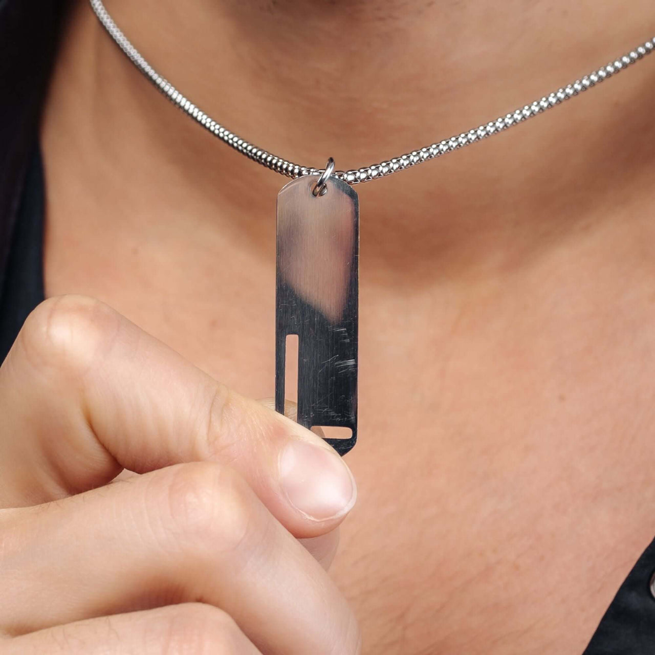 Charming Initial Necklace worn by a man, featuring a sleek silver letter pendant by Brother & Sisters.