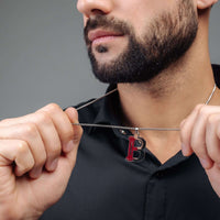Thumbnail for Man wearing Rugby Initial Necklace by Brother & Sisters, showcasing a bold silver letter pendant.