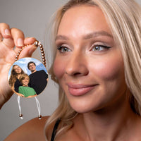 Thumbnail for Woman holding a Metallic Photo Bracelet featuring a family photo, showcasing Brother & Sisters custom jewelry.