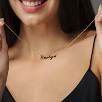Thumbnail for Minimalist Name Necklace held by a woman, showcasing gold personalized design from Brother & Sisters.