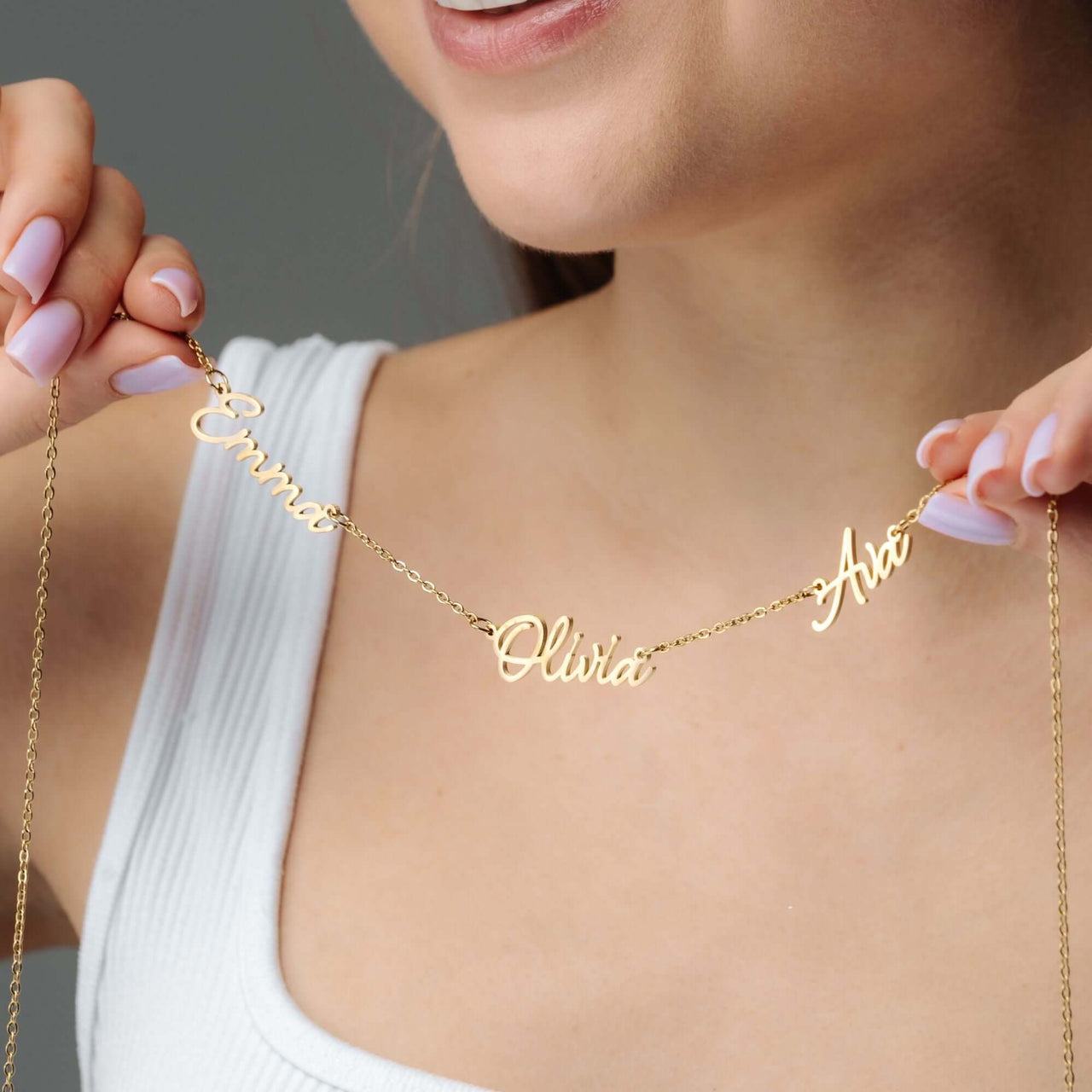 Close-up of a woman wearing a Multi Name Necklace showcasing custom names, crafted by Brother & Sisters.