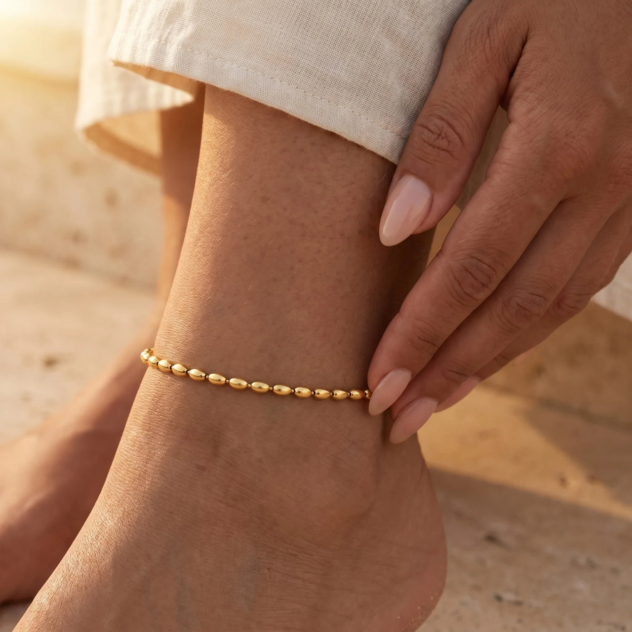 Oval Bead Anklet showcasing tiny gold beads wrapping the ankle, crafted by Brother & Sisters.
