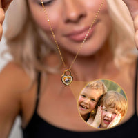 Thumbnail for Woman showcasing a Padlock Photo Necklace by Brother & Sisters, featuring a photo of smiling children inside.