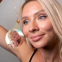 Thumbnail for Woman wearing a Padlock Photo Necklace by Brother & Sisters, showcasing a photo of her children inside the pendant.