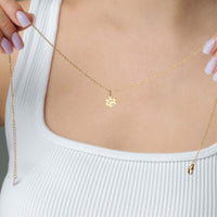 Thumbnail for Paw Name Necklace held by a person, showcasing the delicate gold chain and personalized charm, made by Brother & Sisters.