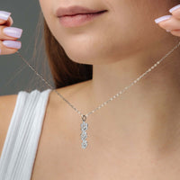 Thumbnail for Model wearing a Paw Name Necklace by Brother & Sisters, showcasing its elegant design and personalized charm.