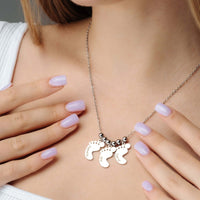 Thumbnail for Child Name Necklace featuring personalized footprint charms by Brother & Sisters, a unique keepsake for celebrating childhood.
