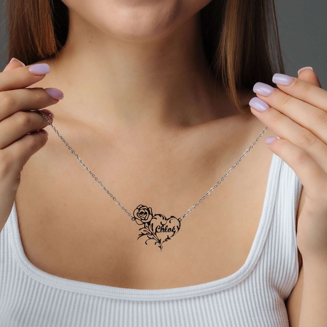 Rose Name Necklace worn by a model, featuring a personalized heart shape with a rose, from Brother & Sisters.