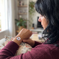 Thumbnail for Woman looking at her husband's photo in the rose gold octagon photo bracelet | SKU: TPH-OCTB-ROSEGOLD-18
