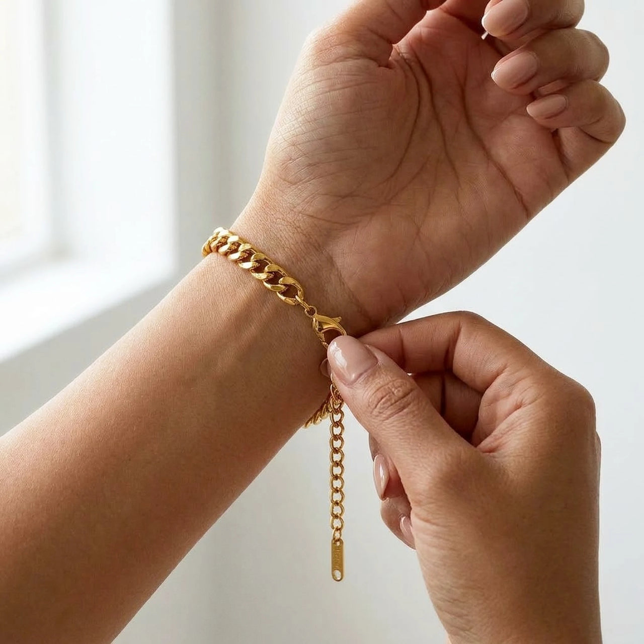 The gold round photo bracelet on the wrist, showing the lobster clasp and extension chain | SKU: TPH-RNDB-GOLD