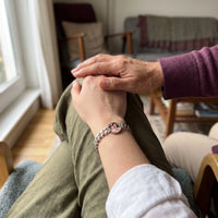 Thumbnail for Mother's hand over her daughter's, the silver round photo bracelet on the daughter's wrist | SKU: TPH-RNDB-SILVER