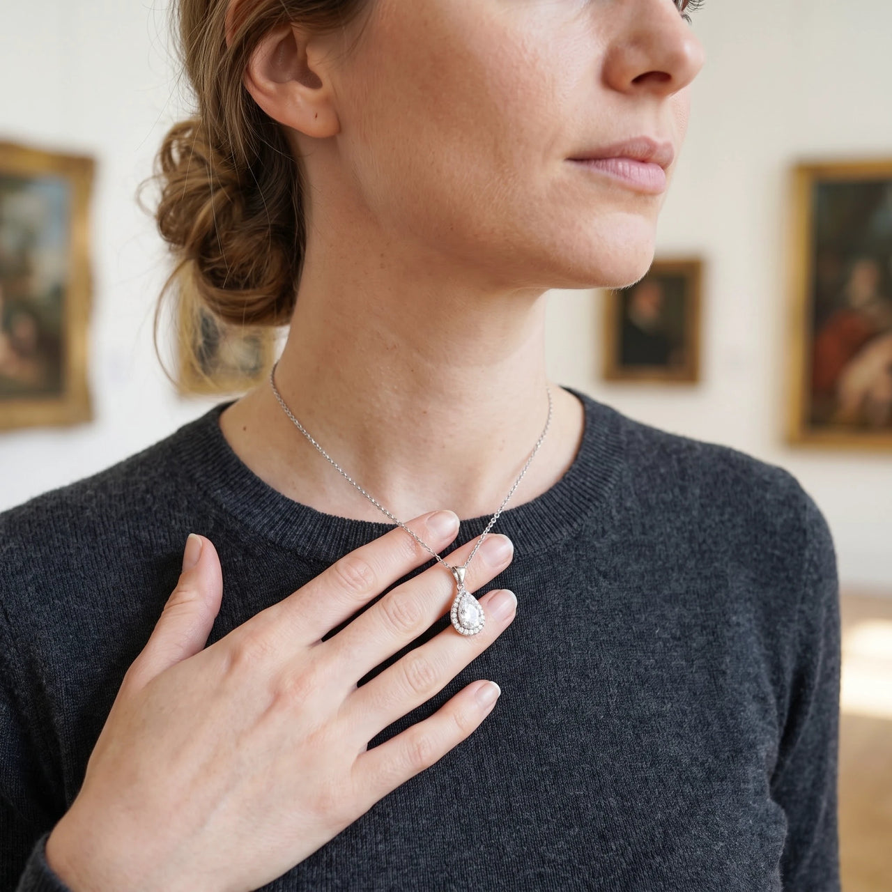 Woman gently touching her silver necklace | SKU: 505415-white