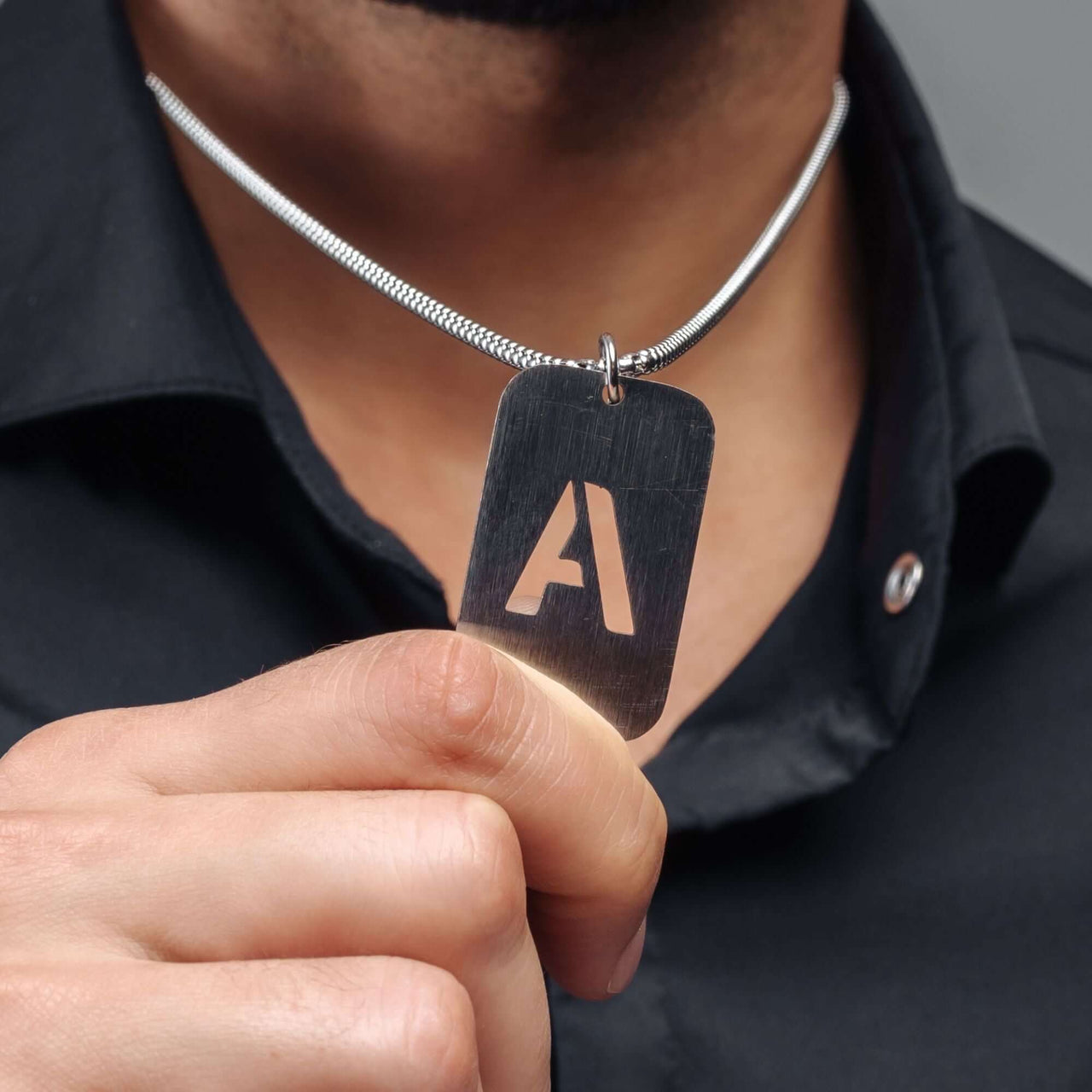 Army Initial Necklace worn by a man showcasing personalized silver design by Brother & Sisters.