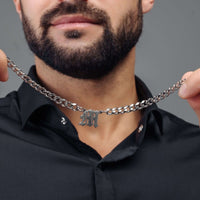 Thumbnail for Man showcasing the bold Silver Fire Initial Necklace by Brother & Sisters, featuring a sleek chain and personalized initial.