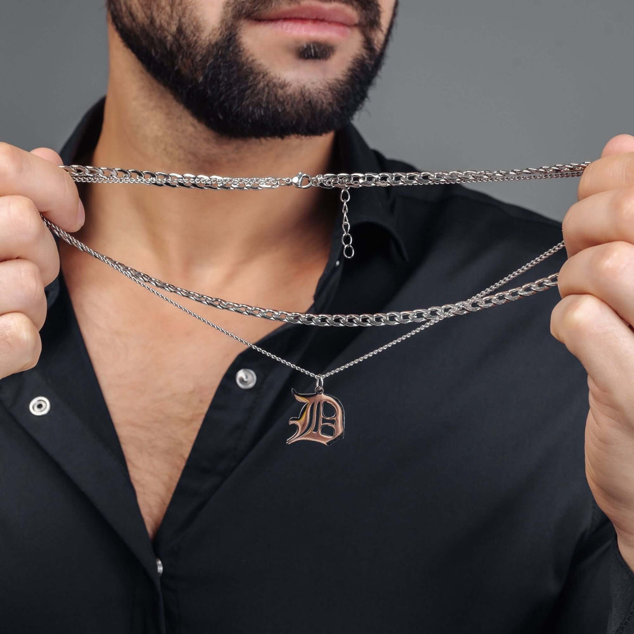 Man wearing Silver Unique Initial Necklace by Brother & Sisters, showcasing personalized jewelry style.