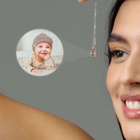 Thumbnail for Close-up of a woman smiling, wearing a Square Photo Necklace featuring a cherished child’s photo by Brother & Sisters.