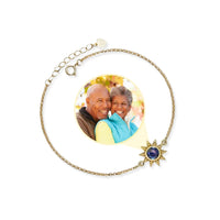 Thumbnail for Sun Photo Bracelet by Brother & Sisters featuring a sun-shaped charm and a hidden photo of a happy couple.