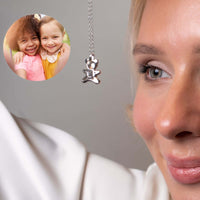 Thumbnail for Teddy Bear Photo Necklace worn by a woman, showcasing a projection of cherished memories with kids in the pendant.