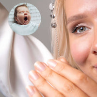 Thumbnail for Close-up of a woman wearing the Tulip Photo Bracelet, showcasing a hidden photo projection of a yawning baby.
