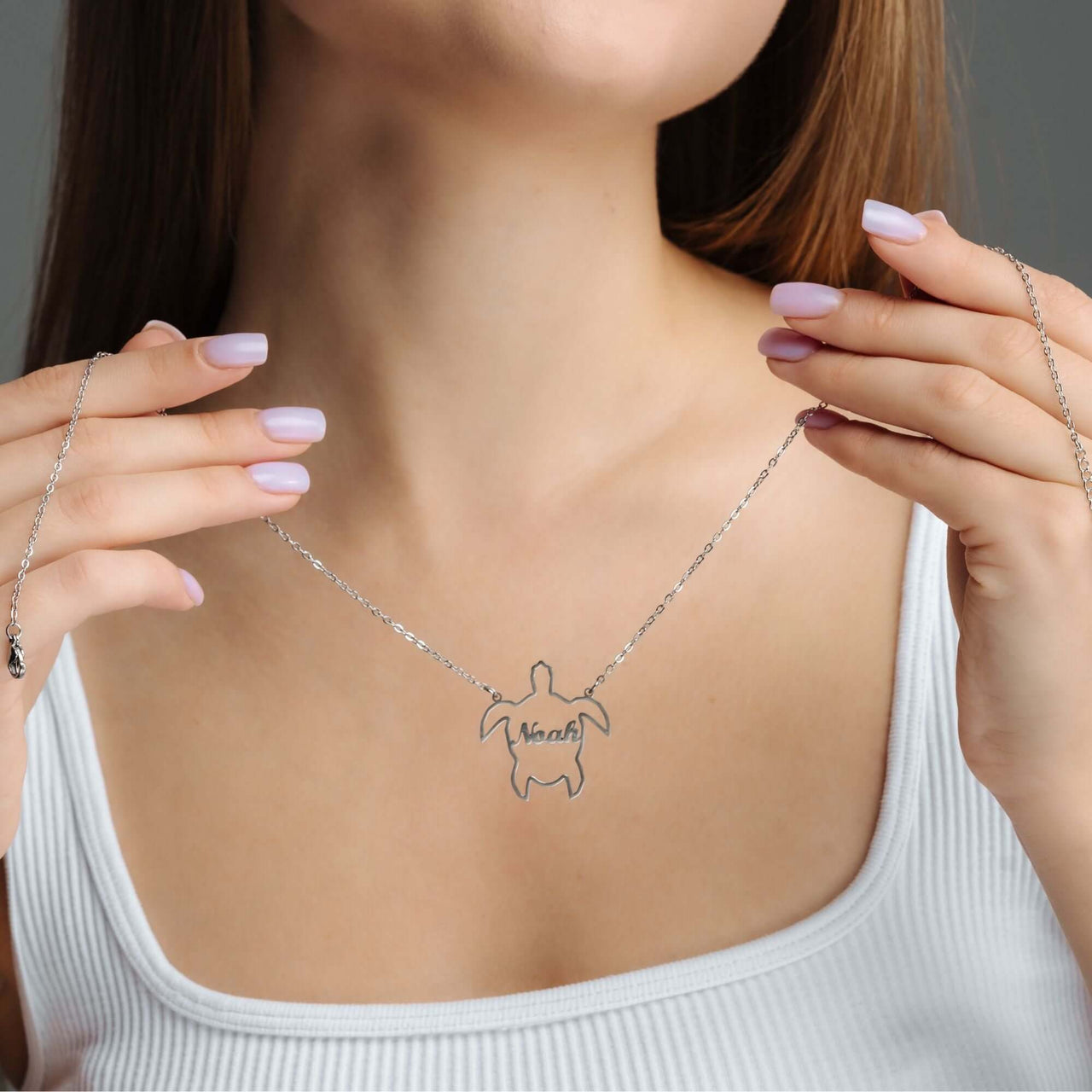 Custom Turtle Name Necklace by Brother & Sisters worn by a woman, showcasing personalized turtle motif with name.
