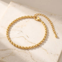 Thumbnail for Elegant Oval Bead Anklet by Brother & Sisters features tiny gold beads, handcrafted detail, pure golden light.