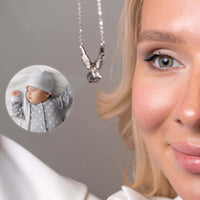Thumbnail for Wings Photo Necklace by Brother & Sisters featuring personalized photo of a sleeping baby in angel wings.