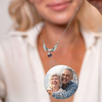 Thumbnail for Wings Photo Necklace from Brother & Sisters featuring elegant angel wings and a personalized photo of a couple.